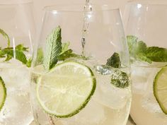 three glasses filled with ice and limes