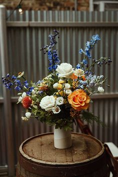 That wedding floral design is elegant for a chic wedding. The bridal experts highly recommend this to transform your bridal procession. Save that to your wedding decor collection. White Orange Blue Wedding Bouquet, Red Yellow Blue Wedding Flowers, Simple Colorful Floral Centerpieces, Blue And Orange Flowers Wedding, Fall Flower Arrangements With Blue, Blue Yellow Orange Flower Arrangements, August Wedding Flowers Centerpieces, Multicolor Fall Wedding, Blue Fall Floral Arrangements