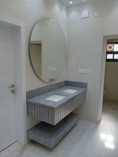 a bathroom with two sinks and a large mirror