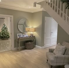 a living room filled with furniture and a christmas tree