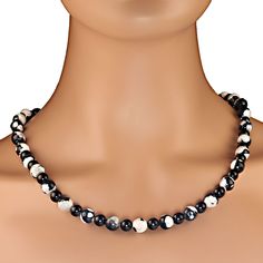 29-Inch Black and White Fire Agate and Black Onyx Necklace – Modern Elegance Elevate your style with this stunning 29-inch black and white necklace, crafted from a striking combination of fire agate and black onyx. The 10mm fire agate beads feature captivating black-and-white mottled patterns, while the highly polished black onyx accents, in 8mm and 6mm sizes, provide a sleek and sophisticated contrast. This modern yet timeless necklace pairs effortlessly with any outfit, making it a versatile a Black And White Necklace, Black And White Necklaces, Monochromatic Color Scheme, Black Onyx Necklace, Onyx Necklace, Fire Agate, Modern Necklaces, White Necklace, Agate Beads