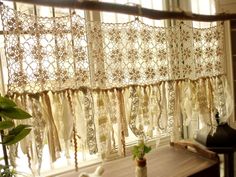 the curtains are hanging on the window sill in front of the table and chair