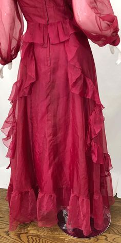 For Sale on 1stDibs - Fantastic mid 1970s burgundy ruffle maxi dress! Features intricate ruffle details on the front and back. Hidden metal zipper up the back with hook-and-eye Party Maxi Dress With Ruffles, Vintage Dresses With Ruffles And Long Skirt, Red Dress With Ruffles And Long Skirt, Silk Long Skirt Dress With Ruffles, Vintage Floor-length Maxi Dress With Ruffles, Vintage Floor-length Ruffled Maxi Dress, 70’s Maxi Dresses, 70’s Maxi Dress, 1970s Vintage Dress With Ruffles