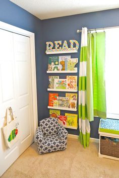 a child's bedroom with blue walls and green curtains