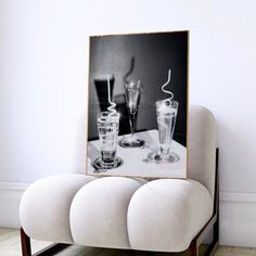 two glasses are sitting on a table with a black and white photo