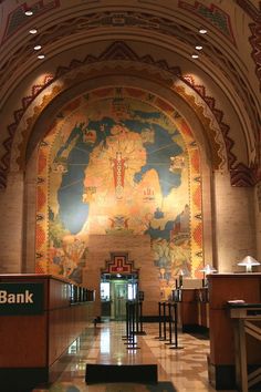 an ornately decorated bank lobby with paintings on the walls