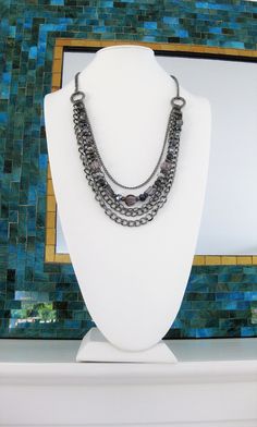 "Multi Strand Grey and Gunmetal Beaded Necklace, handmade by Ralston Originals. This beaded necklace includes a collection of beautiful crystal, glass, metal, and acrylic beads, in grey, silver, and black. The chain is gunmetal, and has multi strands of 4 different sizes and types of chain. This beaded necklace is 32 inches long, has a lobster clasp, and 3 inch extension chain. This black and grey beaded necklace is ready to send today, and it includes free shipping in the USA. I carefully packa Metal Beaded Necklaces With Round Beads, Silver Faceted Beads Metal Beaded Necklaces, Silver Metal Beaded Necklace With Faceted Beads, Metal Chain Necklace With Beaded Chain, Metal Chain Necklace With Round Beaded Chain, Silver Beaded Rhinestone Necklace, Silver Beaded Rhinestone Necklace In Metal, Metal Beaded Necklaces With Silver Beads, Silver Multi-strand Metal Beaded Necklaces