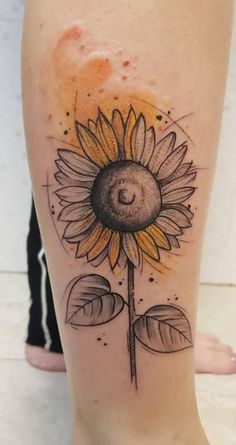 a sunflower tattoo on the leg