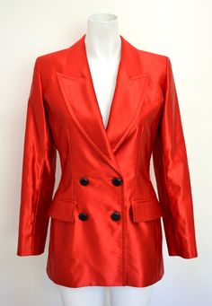 Red satin blazer by Yves Saint Laurent, beautiful piece from the late 1980s. It features a blazer necklace, with two pockets on the front hips. It closes with four black round buttons on the front. (As reference the model Flo measures 1m78) Labeled Yves Saint Laurent Variation Made in France. 70% cotton 30% silk Size: FR 40 (please see the measurements below). Good vintage condition, the fabric has some discreet snags behind the right shoulder (please see the last picture). Lining in perfect con Red Single-breasted Evening Blazer, Red Single-breasted Blazer For Evening, Red Single Breasted Blazer For Evening, Elegant Satin Outerwear With Button Closure, Red Evening Blazer For Spring, Designer Party Blazer With Button Closure, Classic Party Blazer With Button Closure, Classic Blazer With Button Closure For Party, Luxury Satin Blazer For Fall