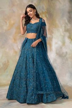 a woman in a blue lehenga