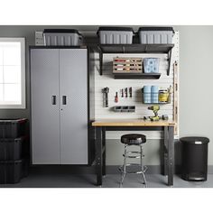 an organized garage with storage cabinets and stools