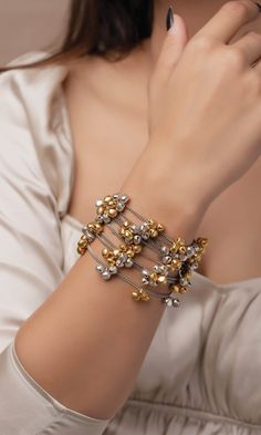 This collection is our best seller for a reason: it’s perfect amalgamation of traditional and modern designs. They are super versatile and light weight. This beautiful bracelet is handcrafted to perfection using fine quality brass, ghungroos with light silver and gold plating on it. Fusion Style Bracelet Jewelry For Party, Metal Bangle Bracelets For Celebration, Festive Fusion Metal Bracelets, Fusion Style Party Bracelet, Gold Dual-tone Brass Jewelry, Dual-tone Gold Brass Jewelry, Adjustable Metal Bracelets For Celebration, Adjustable Metal Bracelet For Celebration, Metal Bangle Jewelry For Celebration