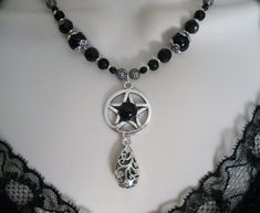 "This beautiful necklace has black obsidian beads, seed beads, black Czech glass beads, pewter silver bead caps, sterling silver plated filigree beads, pewter silver pentacle with black obsidian setting and a pewter silver scroll drop. 18\" long. Toggle clasp." Pentacle Necklace, Wicca Jewelry, Pagan Necklace, New Plymouth, Wiccan Jewelry, Pagan Jewelry, Gothic Necklace, Black Obsidian, Silver Bead