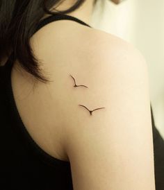 a woman with a small tattoo on her shoulder