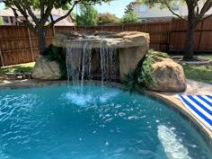 a small pool with a waterfall in the middle