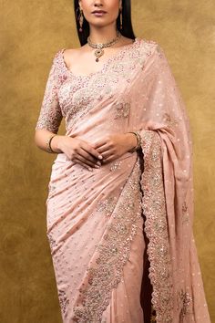 Editor's Note Rose Pink Chiffon Booti Saree With Delicate Gota Work Color: Pink Fabric: Chiffon Components: Sari & Blouse Care: Dry Clean Only About the Designer Nitika Gujral’s journey with designing clothes started almost four decades back while she was still in high school and held her first exhibition for family and friends. Making clothes has been a part of her life ever since. Pink Formal Blouse With Traditional Drape, Elegant Pink Blouse With Sheer Dupatta, Formal Pink Blouse Piece With Dupatta, Pink Bollywood Style Pre-draped Saree For Formal Occasions, Chiffon Blouse With Traditional Drape For Wedding, Traditional Drape Chiffon Blouse For Wedding, Wedding Blouse In Georgette With Cutdana, Semi-stitched Georgette Blouse For Wedding, Wedding Blouse With Cutdana On Georgette