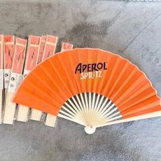 an orange fan sitting on top of a cement floor