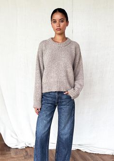 A woman wearing a round neck sweater with ribbed hem and cuffs. Barrel Denim Outfit, Barrel Leg Trouser Outfit, Fall Barrel Jean Outfits, Outfits With Barrel Jeans, Barrel Leg Pants Outfit, Barrel Jean Outfit, Styling Barrel Leg Jeans, Barrel Jeans Outfit Fall, Barrel Jeans Street Style