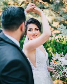 a woman in a wedding dress standing next to a man