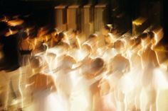 blurry photograph of people dressed in white