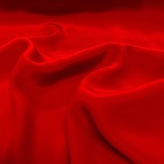 red silk fabric with very smooth lines and folds in the center, as well as an abstract background