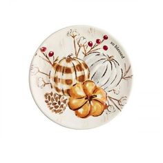 a white plate with pumpkins and leaves painted on it