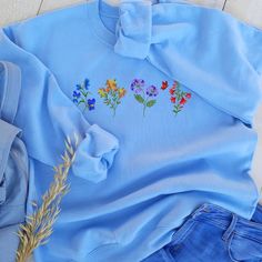 Embroidered Flowers Sweatshirt Unisex Floral Embroidered - Etsy Embroidered Relaxed Fit Sweater For Spring, Relaxed Fit Embroidered Sweater For Spring, Blue Tops With Letter Embroidery For Spring, Casual Crew Neck Sweater With Multicolor Embroidery, Long Sleeve Sweatshirt With Letter Embroidery For Spring, Spring Relaxed Fit Sweater With Embroidered Graphics, Blue Sweatshirt With Letter Embroidery For Spring, Floral Embroidery Cotton Sweatshirt For Spring, Crew Neck Sweater With Custom Embroidery For Spring