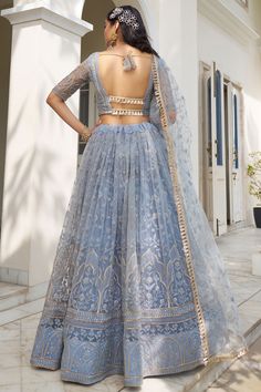 Drape yourself in elegance with this exquisite designer lehenga, crafted from luxurious net fabric. The intricate sequins work adds a touch of sparkle, making it perfect for your special occasions and festive gatherings. Whether it's a wedding reception or a glamorous party, this lehenga is sure to make you the center of attention. Pair it with a stylish blouse and dupatta to complete your stunning ensemble. Elevate your ethnic wardrobe with this mesmerizing creation, designed to make you look and feel like royalty. Dusty Blue Lehenga, Indian Outfits Modern Weddings, Engagement Dress Indian, Lehenga Pastel, Ice Blue Lehenga, Indian Cocktail Dress, Blue Lengha, Indian Royalty