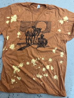 "Sunset Cowboy" Horse & Cowboy Design Available In Cream, White, or Heather Harvest Graphic Tee Super Soft & Stretchy Cotton Tee Unisex Cut ~ Runs Roomy ~ If You Want A More Fitted Tee We Recommend You Size Down Women's Sizing Recommendations Small 0/2/4 Medium 4/6/8 Large 8/10/12 XLarge 12/14/16 2XLarge 16/18/20 3XLarge 20/22/24 ***These Are PRINTED/MADE TO ORDER! Please Allow 7-10 Business Days To Ship. If You Order Multiple Items, These Will Be Shipping Out SEPARATELY From Your Order. Vintage Bleached Tops For Summer, Hand Dyed Yellow Tops For Summer, Hand Dyed Yellow Top For Summer, Faded Summer Top, Summer Faded Pre-washed Tops, Summer Cotton Bleached Shirt, Summer Graphic Tee Shirt In Brown, Summer Relaxed Fit Pre-washed Shirt, Summer Brown Graphic Tee Shirt