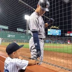 two baseball players standing next to each other on a field