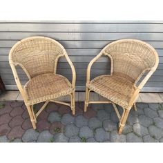 two wicker chairs sitting next to each other