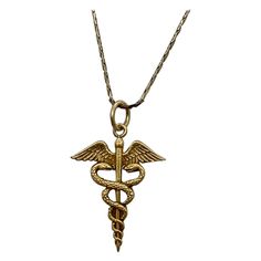 INDULGE IN A WONDERFUL CADUCEUS PENDANT WITH ENTWINED SNAKES IN 10 KARAT YELLOW GOLD. The caduceus is a symbol that features two snakes wrapped around a staff, often with wings, and is associated with medicine, Hermes, and peaceful dispute resolution. THE CADUCEUS IS OFTEN USED AS A SYMBOL FOR MEDICINE AND IS A WONDERFUL JEWEL FOR THE DOCTOR, NURSE, PA, MD, PHYSICIAN, AS WELL AS LOVERS OF GREEK MYTHOLOGY, AND PEACE AS WELL AS HERMES AND MERCURY, AND LOVERS OF SNAKE JEWELRY. And snake jewelry is all the rage - look at the photo of Naomi Watts from the Oscars I have included! The caduceus is the staff carried by Hermes in Greek mythology. It is a short staff entwined by two serpents, sometimes surmounted by wings. In Roman iconography, it was often depicted being carried in the left hand of Hermes Staff, Greek Necklace, Two Snakes, Victorian Pendant Necklace, Greek Mythology Jewelry, Dispute Resolution, Victorian Pendants, Medicine Doctor, Snake Pendant