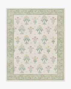 a white and green rug with flowers on it