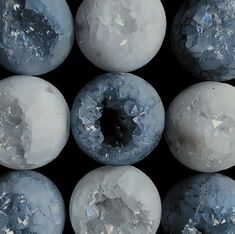 several blue donuts with white frosting on them are arranged in a grid pattern