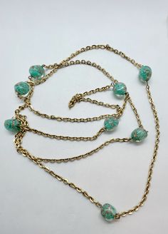 "Gorgeous Murano glass beaded opera length necklace.  The beads are turquoise aqua with gold swirls.  The necklace is 52\" long and can be worn as a single strand over the neck or doubled.  Nice heavy gold cable chain." Turquoise Wire Wrapped Glass Necklaces, Turquoise Glass Wire Wrapped Necklace, Turquoise Wire Wrapped Glass Necklace, Vintage Gold Beaded Turquoise Necklace, Turquoise Glass Necklaces For Party, Turquoise Glass Necklace For Party, Turquoise Glass Party Necklace, Murano Glass Necklaces, Length Necklace