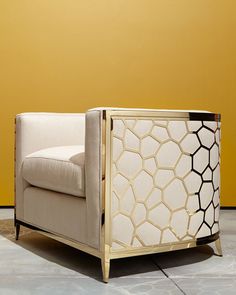 a white chair sitting on top of a tiled floor next to a yellow wall with an animal print covering