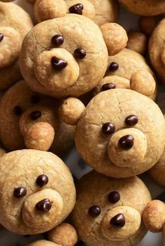 a pile of cookies with chocolate chips in the shape of teddy bear faces on them