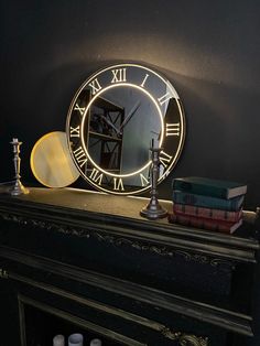 a clock sitting on top of a mantle next to some candles and other things in front of it