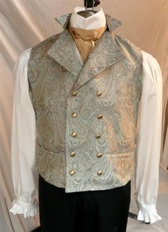 Our very popular English Regency Double Breasted Waistcoat buttons high on the chest, perfect for showcasing a crisp linen shirt and beautiful silk cravat. A special feature of my vests is that the back is made of the same fancy fabric as the front, not just a lining fabric. You choice of buttons:  matte gold, antiqued gold or made of self fabric to match. Plus one extra - just in case! 2 functioning hip pockets, and an adjustable back belt that creates a custom fit for you This is a custom made Fitted Gold Vest Elegant Style, Fitted Gold Elegant Vest, Gold Fitted Vest, Elegant Gold Fitted Vest, Elegant Nehru Jacket With Buttons, Elegant Wedding Vest With Buttons, Fitted Wedding Vest With Buttons, Fitted Vest With Buttons For Wedding, Sleeveless Vest With Buttons For Wedding