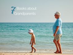 an older man and young boy walking on the beach with water in the back ground