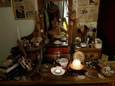 a woman is sitting in front of a dresser full of clutter and other items