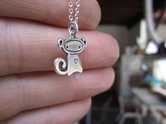 Monkey loves you. This playful little guy measures 1/2 of an inch tall, is made using solid sterling silver, and comes on the chain length and style you choose from the drop down menu. To see the larger version: http://www.etsy.com/listing/94279571/monkey To see the mother-daughter set: http://www.etsy.com/listing/94275656/mother-daughter-monkey-necklace-set And the matching earrings: http://www.etsy.com/listing/94587376/little-monkey-earrings Items are shipped as a gift without a receipt in a c Monkey Earrings, Monkey Necklace, Tiny Monkey, Cute Box, Little Monkeys, Pretty Jewelry, Necklace Sterling Silver, Pretty Jewellery, Cute Jewelry