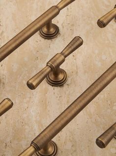 several brass colored handles and knobs on a marble surface