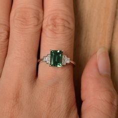 It is a lab green sapphire ring. The main stone is 6 mm*8 mm emerald cut.weight about 1.70 carats. The basic metal is sterling silver and plated with rhodium/14k white gold/14k rose gold/14k yellow gold You can also go to my shop Home for more elegant rings: https://www.etsy.com/shop/godjewelry?ref=hdr_shop_menu Customization is always welcome and please feel free to contact with me if you have any design ideas! Silver Emerald Cut Ring For May Birthstone, Silver Radiant Cut Emerald Ring For May Birthstone, Sterling Silver Emerald Cut Ring For May Birthstone, Radiant Cut Silver Emerald Ring For May Birthstone, Gia Certified Green Square Cut Jewelry, Emerald Cut Diamond Ring For May Birthstone, May Birthstone Emerald Cut Emerald Ring, Green Sterling Silver Jewelry With Baguette Cut, Modern Green Emerald-cut Jewelry