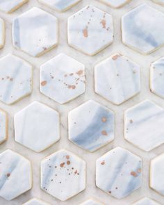 some white and brown hexagonal tiles with rust on them