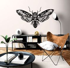 a living room filled with furniture and a butterfly wall decal