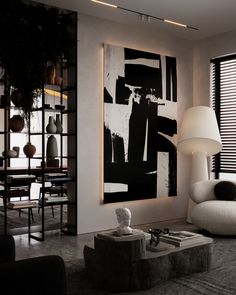 a living room with black and white artwork on the wall