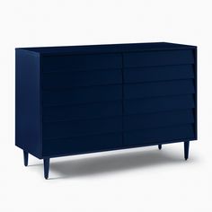 a dark blue dresser sitting on top of a white floor