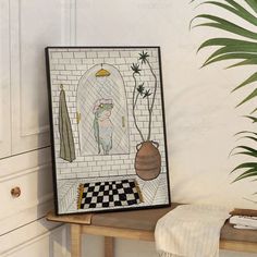 a painting on the wall next to a potted plant and a checkered table cloth