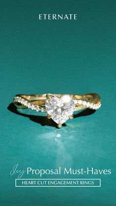 an engagement ring with a heart shaped diamond in the center on a green background that says,